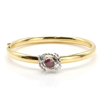 Lot 191 - An 18ct gold ruby and diamond bangle
