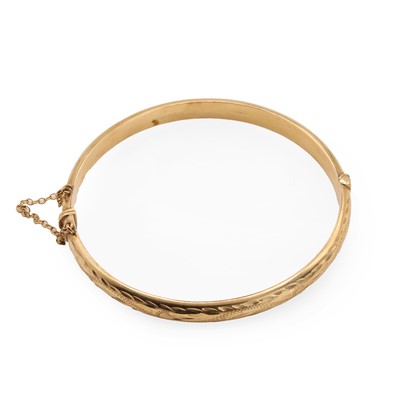 Lot 74 - A 9ct gold hinged bangle