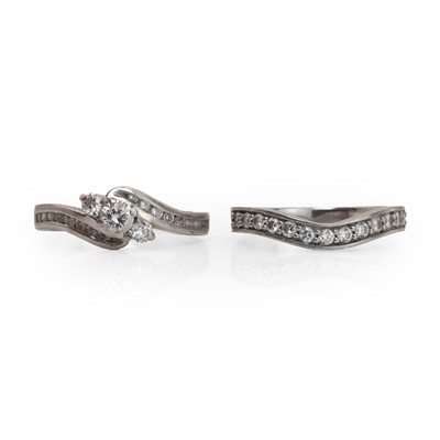 Lot 162 - A platinum and diamond ring with a half eternity ring