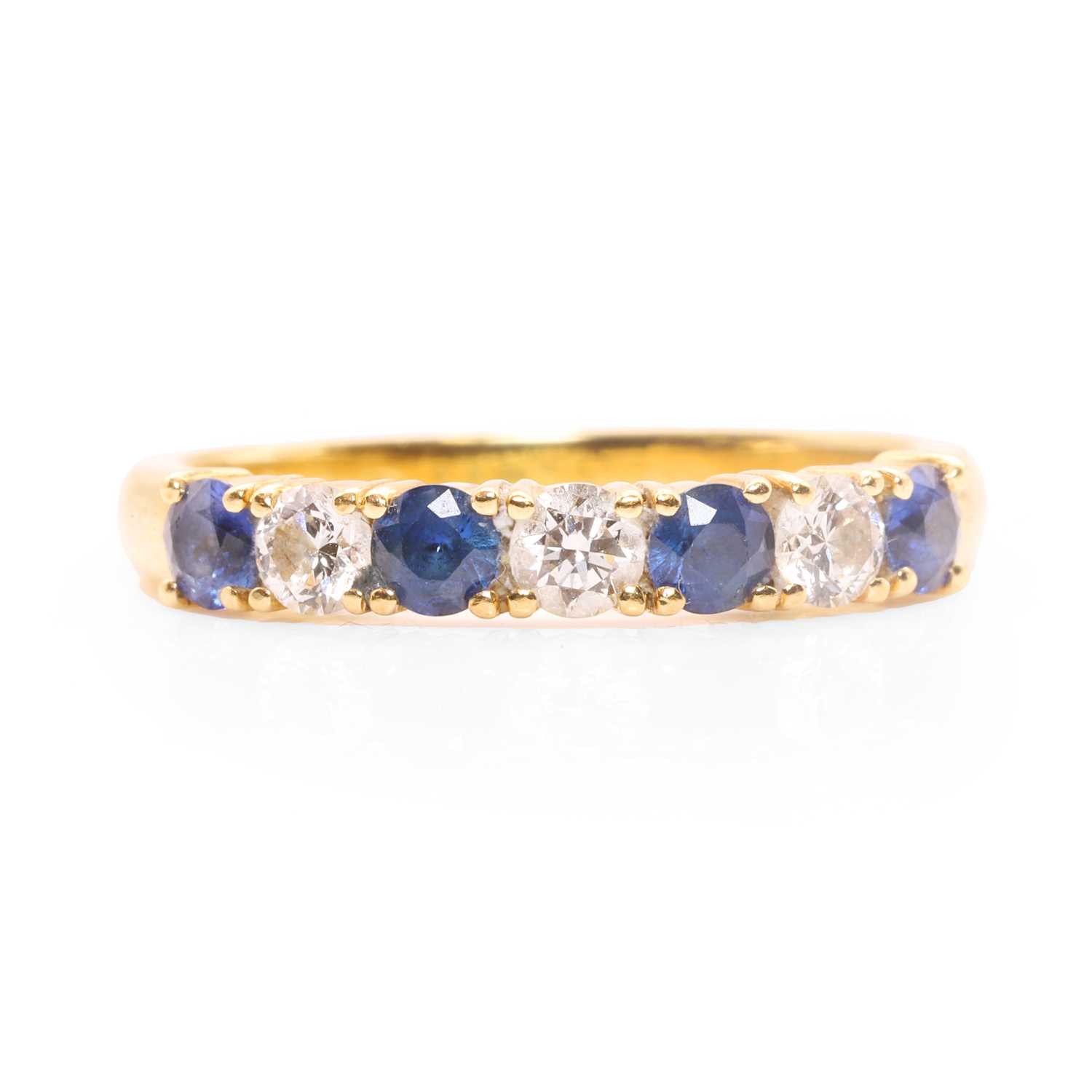 Lot 78 - An 18ct gold diamond and sapphire half eternity ring