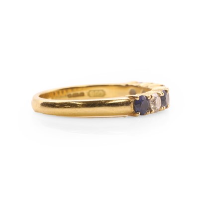 Lot 78 - An 18ct gold diamond and sapphire half eternity ring