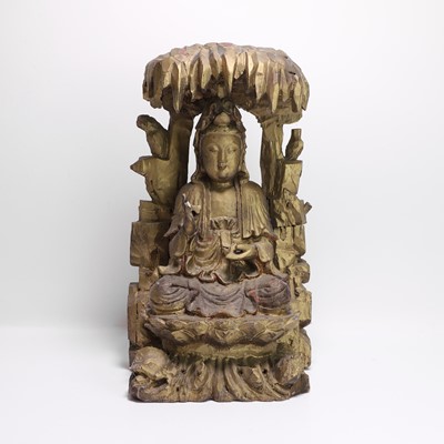 Lot 22 - A Chinese lacquered wood carving of Guanyin