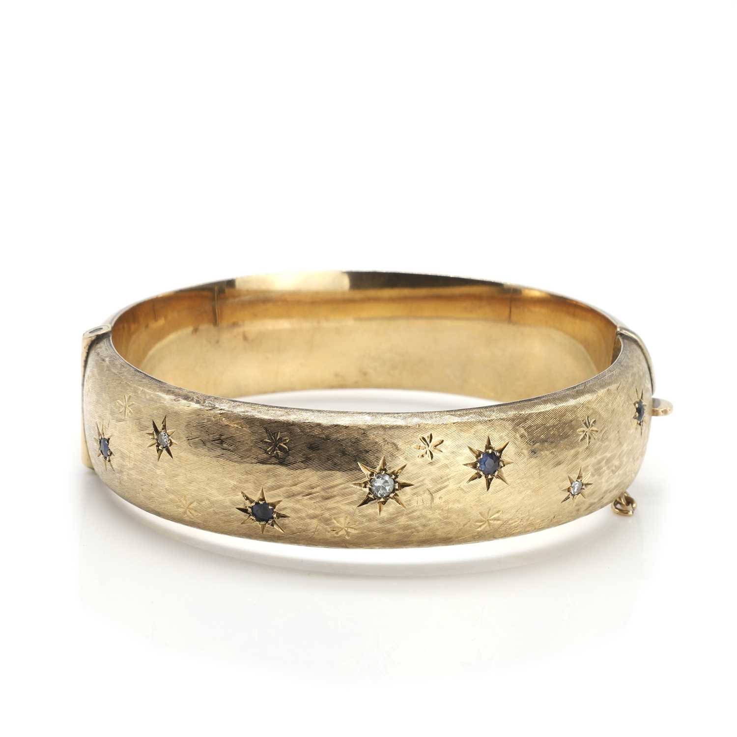 Lot 68 - A 9ct gold sapphire and diamond bangle
