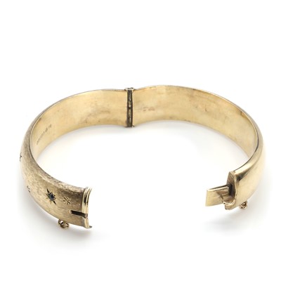 Lot 68 - A 9ct gold sapphire and diamond bangle