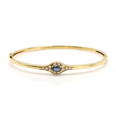 Lot 139 - A 14ct gold sapphire and diamond bangle