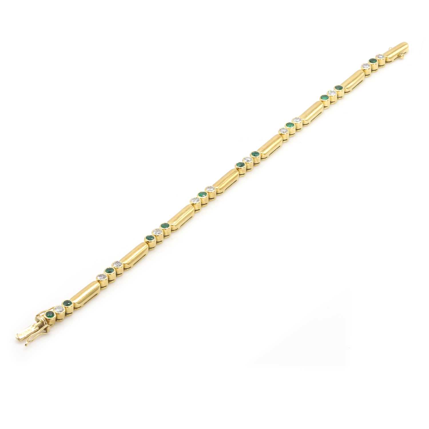 Lot 199 - An 18ct gold emerald and diamond line bracelet, by Garrard & Co
