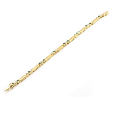 Lot 199 - An 18ct gold emerald and diamond line bracelet, by Garrard & Co