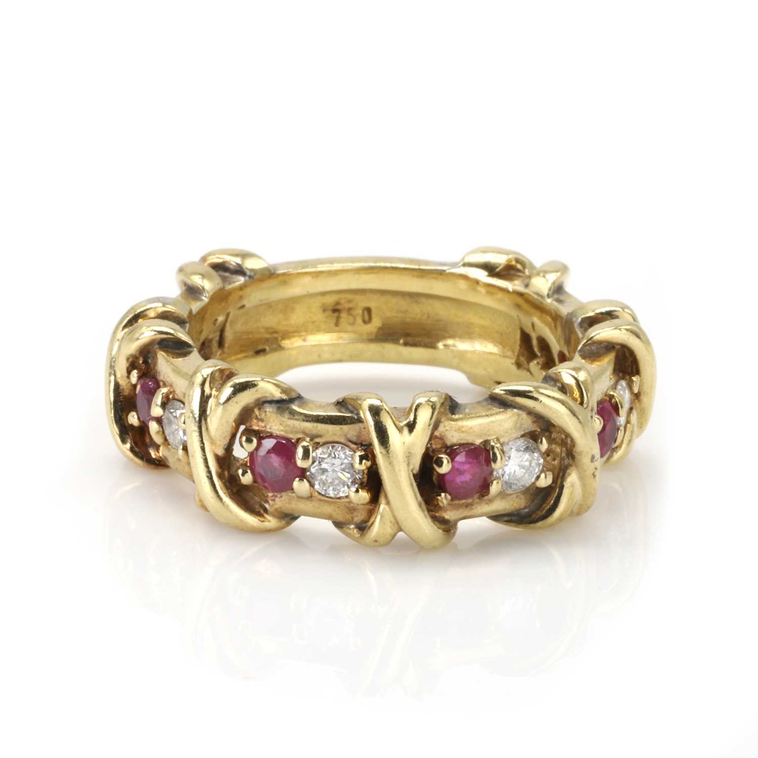 Lot 124 - A gold ruby and diamond band ring