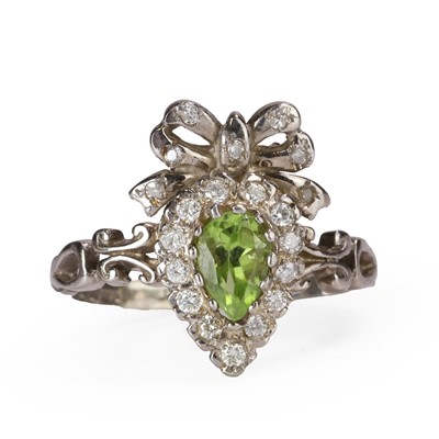 Lot 1084 - A 9ct white gold peridot and diamond cluster bow ring