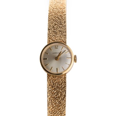 Lot 376 - A ladies' 9ct gold mechanical bracelet watch, by Garrard