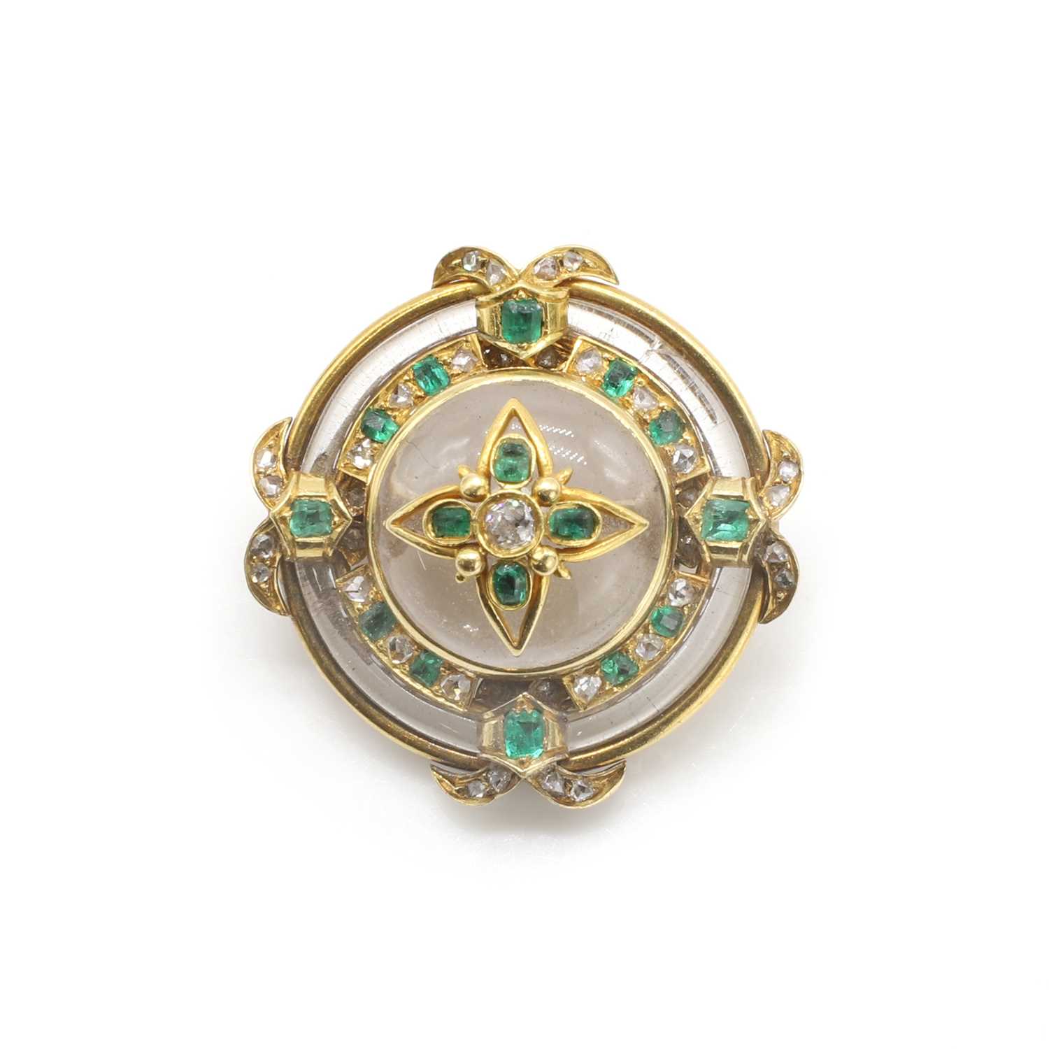 Lot 8 - A shield-form rock crystal, emerald and diamond brooch