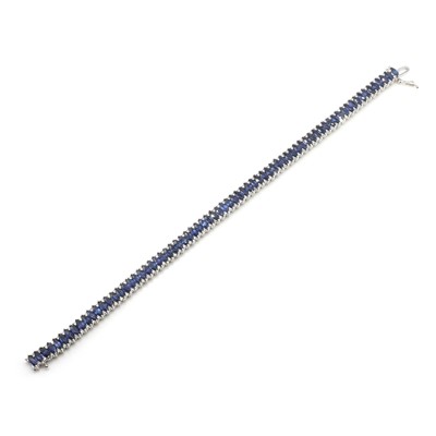 Lot 240 - An 18ct white gold sapphire and diamond line bracelet