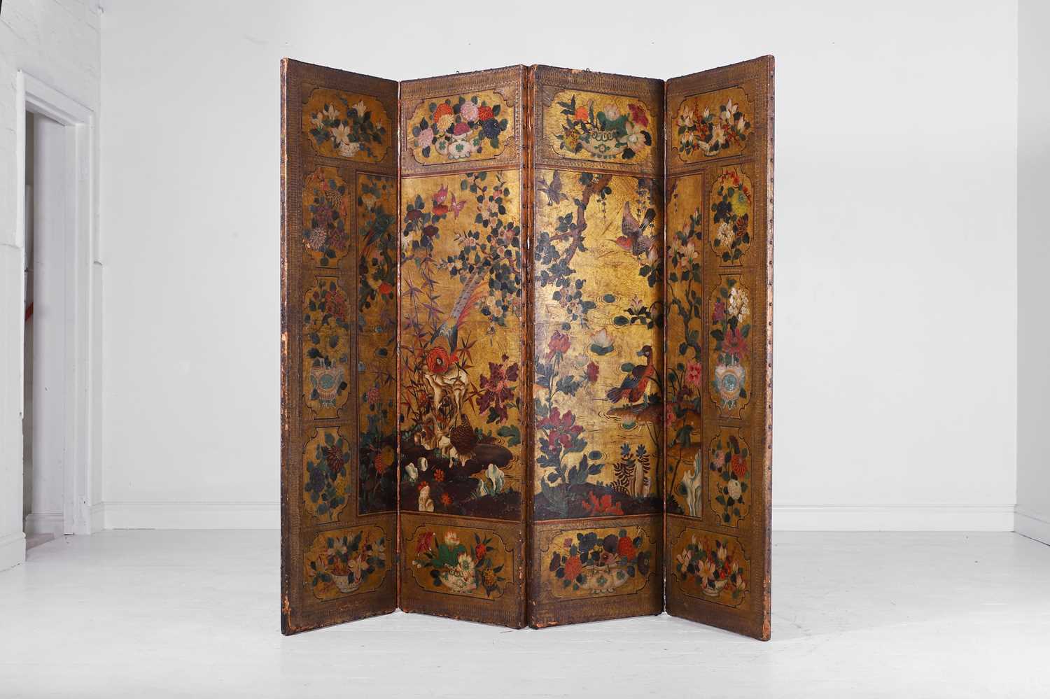 Lot 16 - A painted and gilt leather folding screen