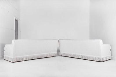 Lot 1 - A pair of upholstered three-seater sofas