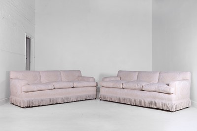 Lot 1 - A pair of upholstered three-seater sofas