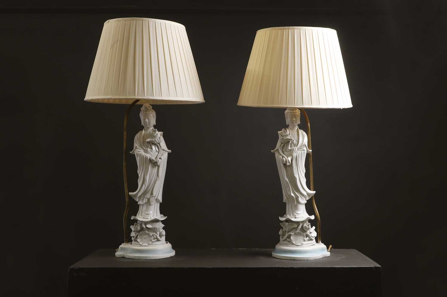 Lot 13 - A pair of blanc de Chine porcelain figural table lamps