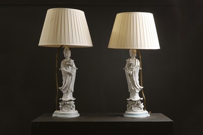 Lot 13 - A pair of blanc de Chine porcelain figural table lamps