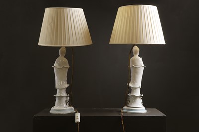 Lot 13 - A pair of blanc de Chine porcelain figural table lamps