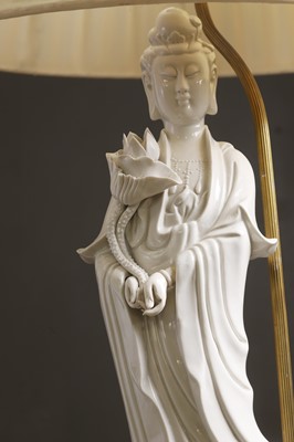 Lot 13 - A pair of blanc de Chine porcelain figural table lamps