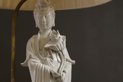 Lot 13 - A pair of blanc de Chine porcelain figural table lamps