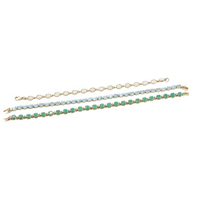 Lot 1195 - A group of three 9ct gold gemstone set line bracelets