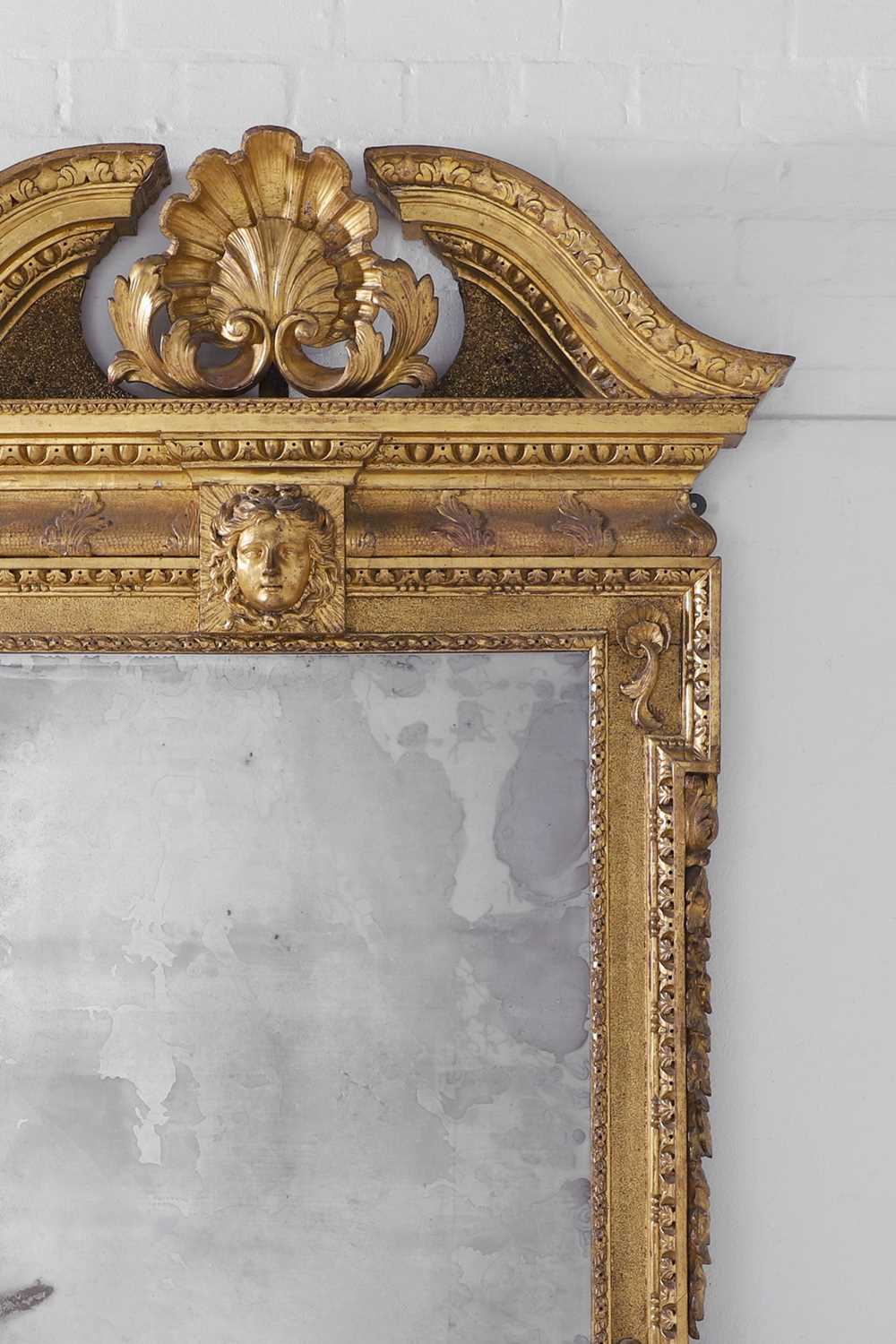 Lot 239 - A George II carved giltwood pier mirror