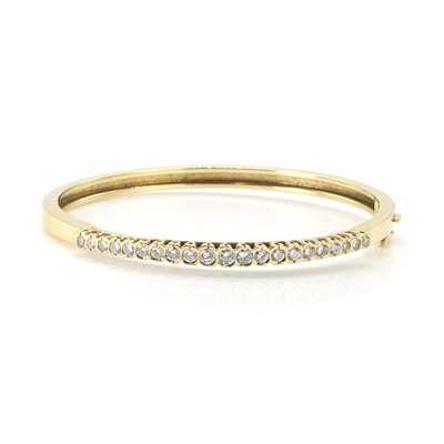 Lot 189 - An 18ct gold diamond hinged bangle