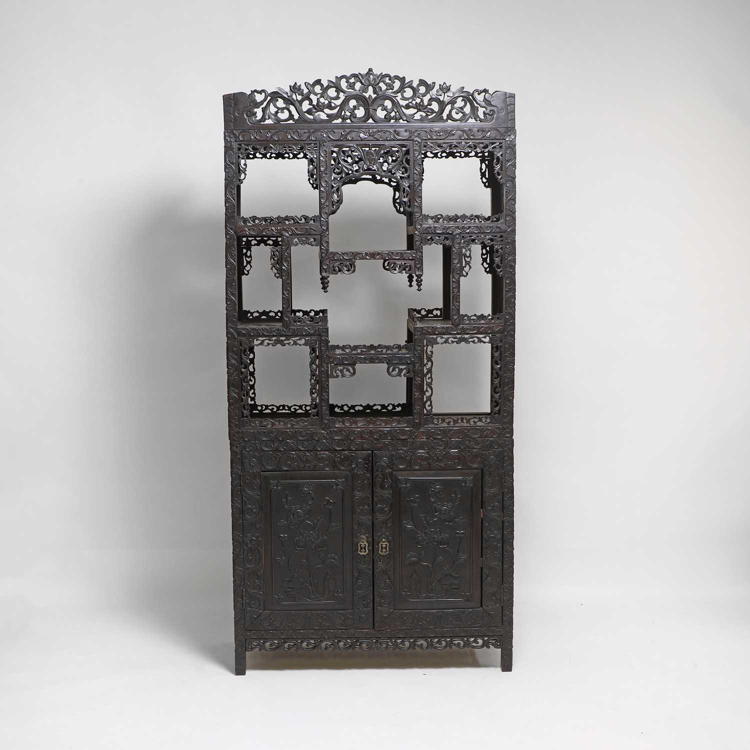 Lot 291 - A Chinese carved hardwood display cabinet