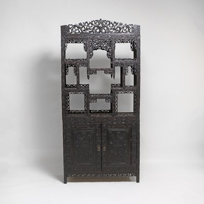 Lot 291 - A Chinese carved hardwood display cabinet