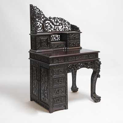 Lot 221 - A Chinese carved hardwood kneehole desk