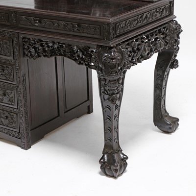 Lot 221 - A Chinese carved hardwood kneehole desk