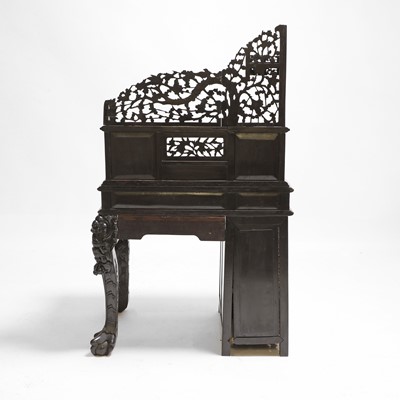 Lot 221 - A Chinese carved hardwood kneehole desk