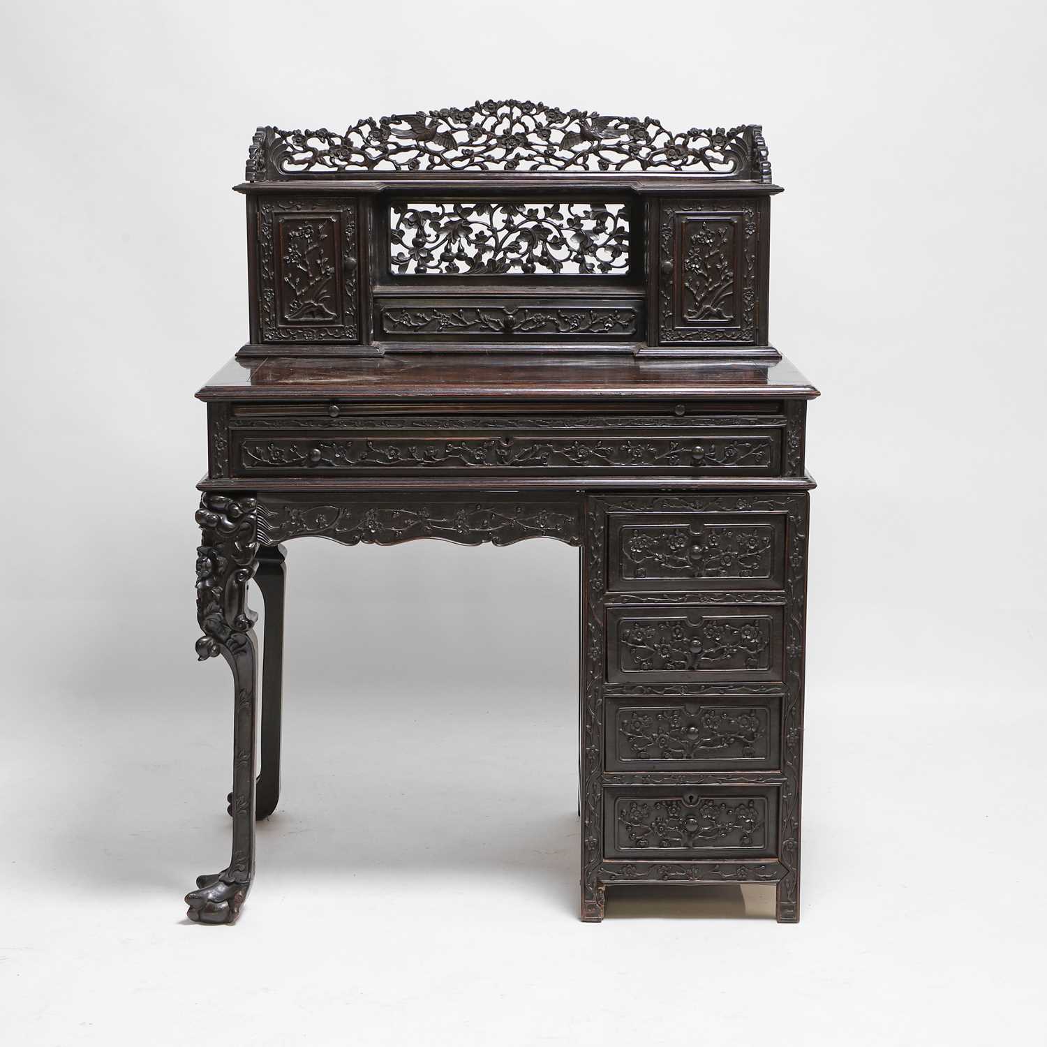 Lot 152 - A Chinese carved hardwood kneehole desk