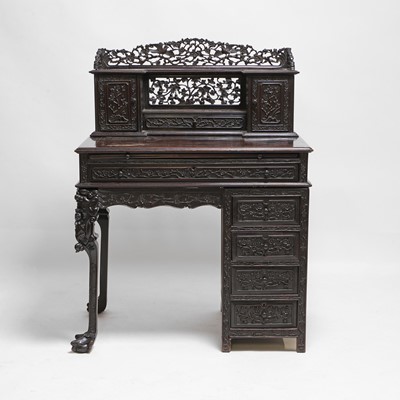 Lot 152 - A Chinese carved hardwood kneehole desk