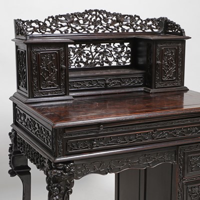 Lot 152 - A Chinese carved hardwood kneehole desk