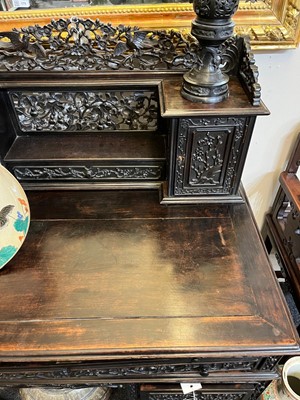 Lot 152 - A Chinese carved hardwood kneehole desk