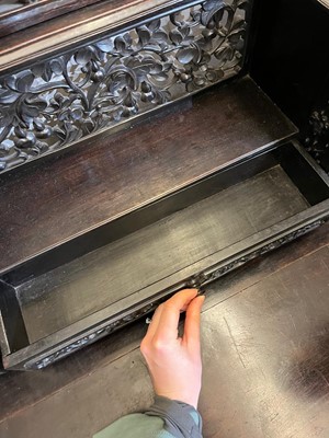 Lot 152 - A Chinese carved hardwood kneehole desk