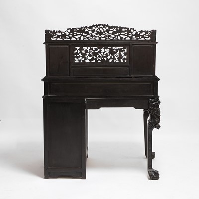 Lot 152 - A Chinese carved hardwood kneehole desk