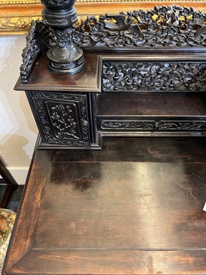 Lot 152 - A Chinese carved hardwood kneehole desk