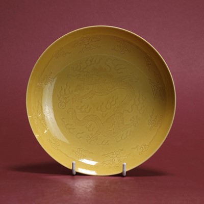 Lot 261 - A Chinese yellow-glazed incised 'dragon' dish