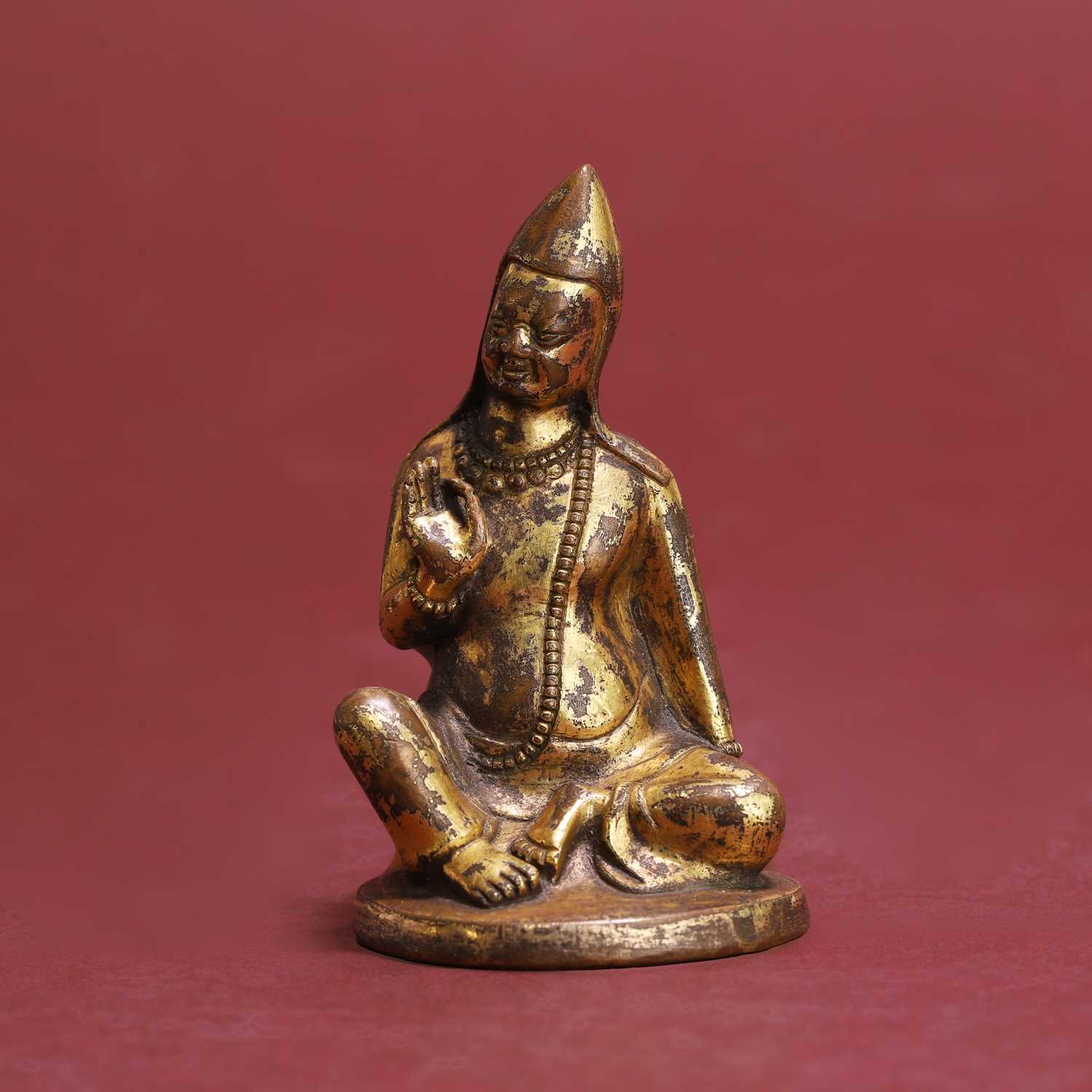 Lot 278 - A small Tibetan gilt-bronze/copper alloy figure of a seated Lama, probably Tsongkhapa
