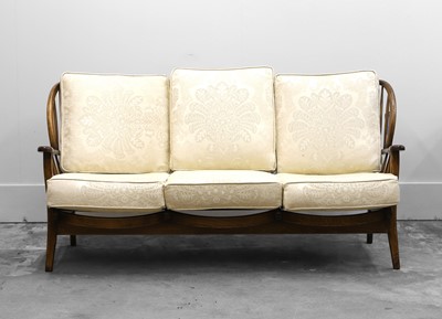 Lot 504 - An Ercol style stained beech settee