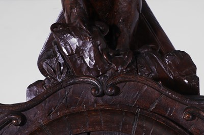 Lot 236 - A Black Forest carved wooden longcase clock