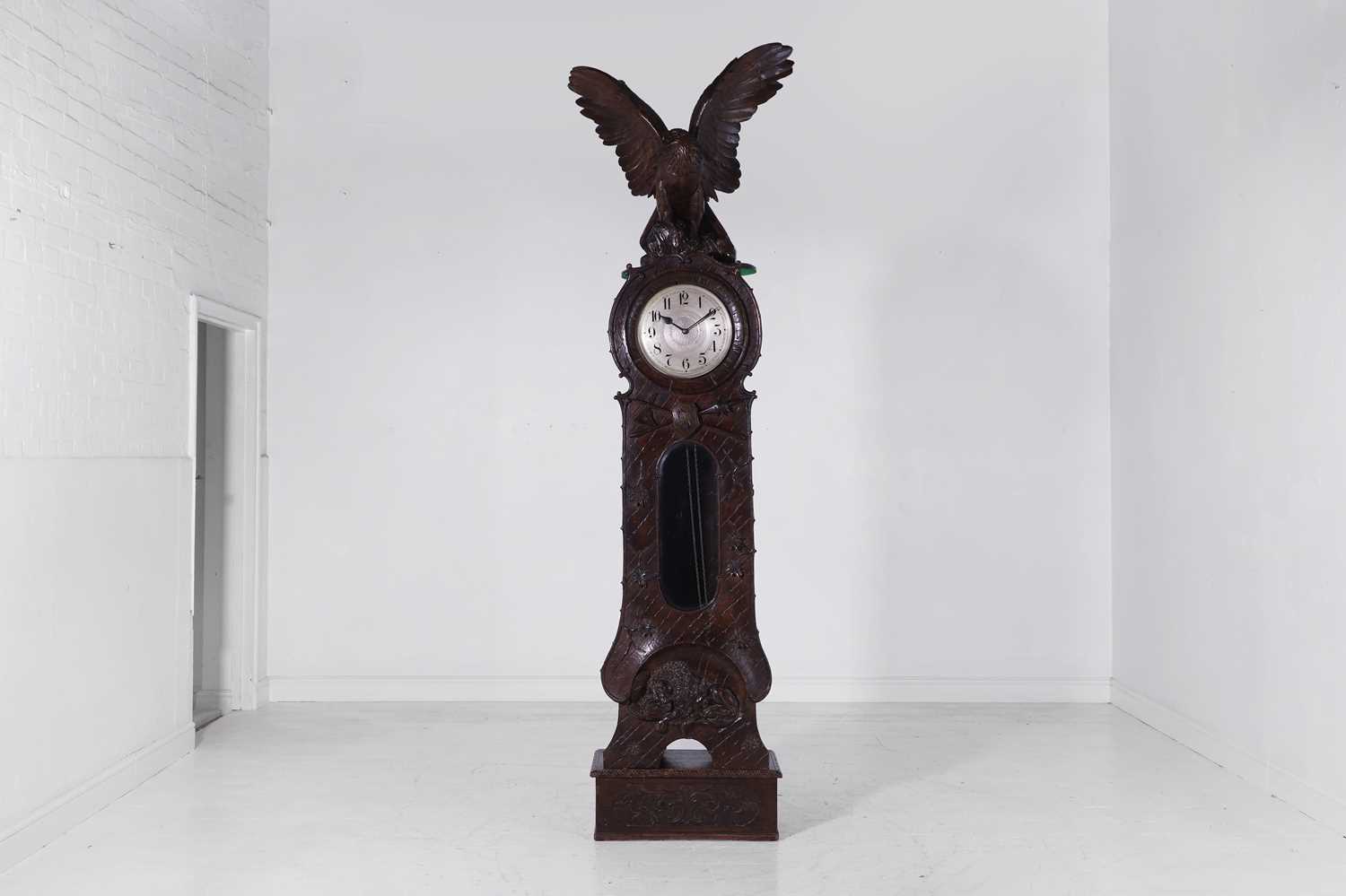 Lot 236 - A Black Forest carved wooden longcase clock