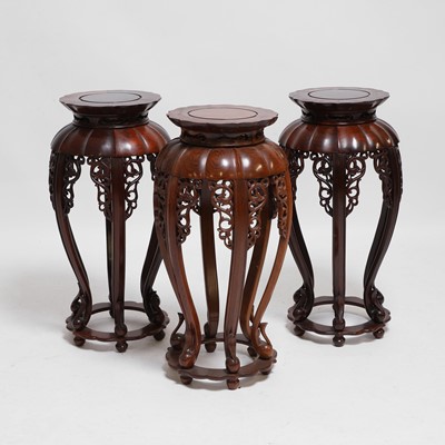 Lot 79 - A set of three Chinese carved hardwood stands