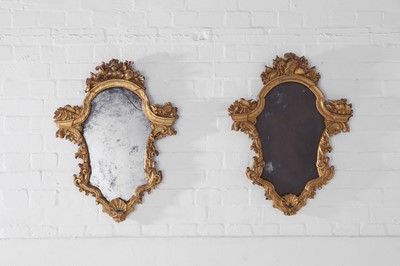 Lot 27 - A pair of rococo carved giltwood girandole mirrors