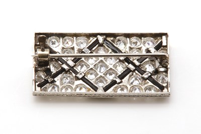 Lot 53 - An Art Deco onyx and diamond plaque brooch