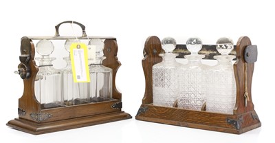 Lot 2 - A pair of oak and silver plated three-bottle tantalus