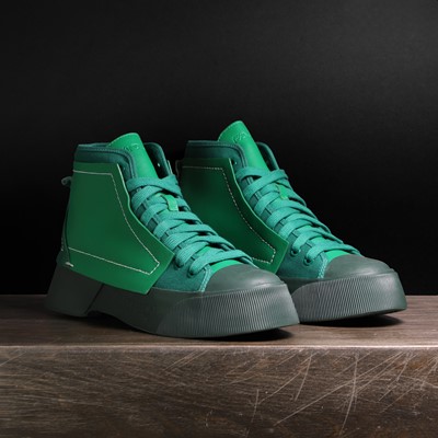 Lot 1402 - A pair of JW Anderson 'Logo' high top sneakers