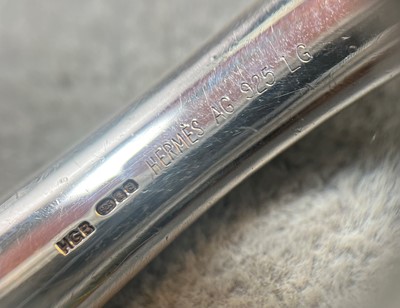 Lot 1117 - A silver bangle, by Hermès